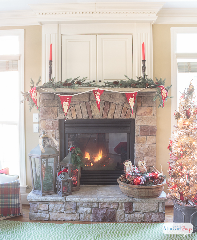 I love all the vintage and rustic Christmas decor she used to decorate this gorgeous stone fireplace mantel for the holidays.
