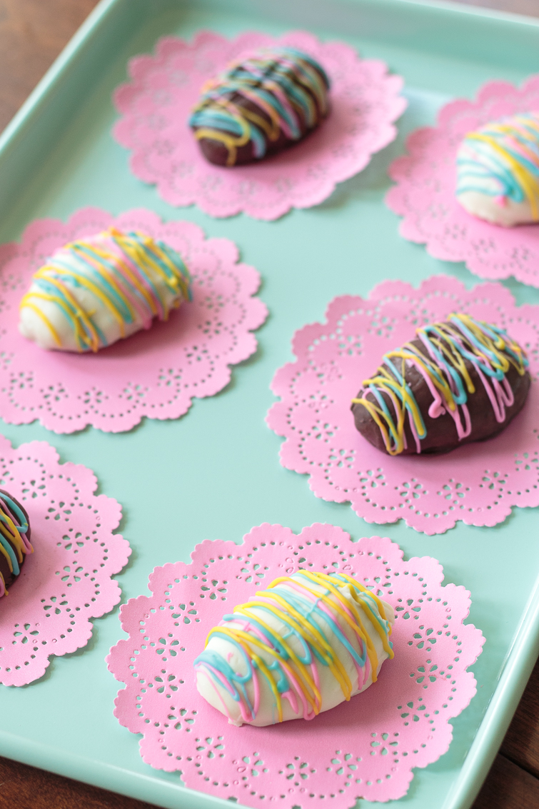aqua cookie sheet filled with white chocolate and dark chocolate peanut butter Easter eggs and coconut Easter eggs