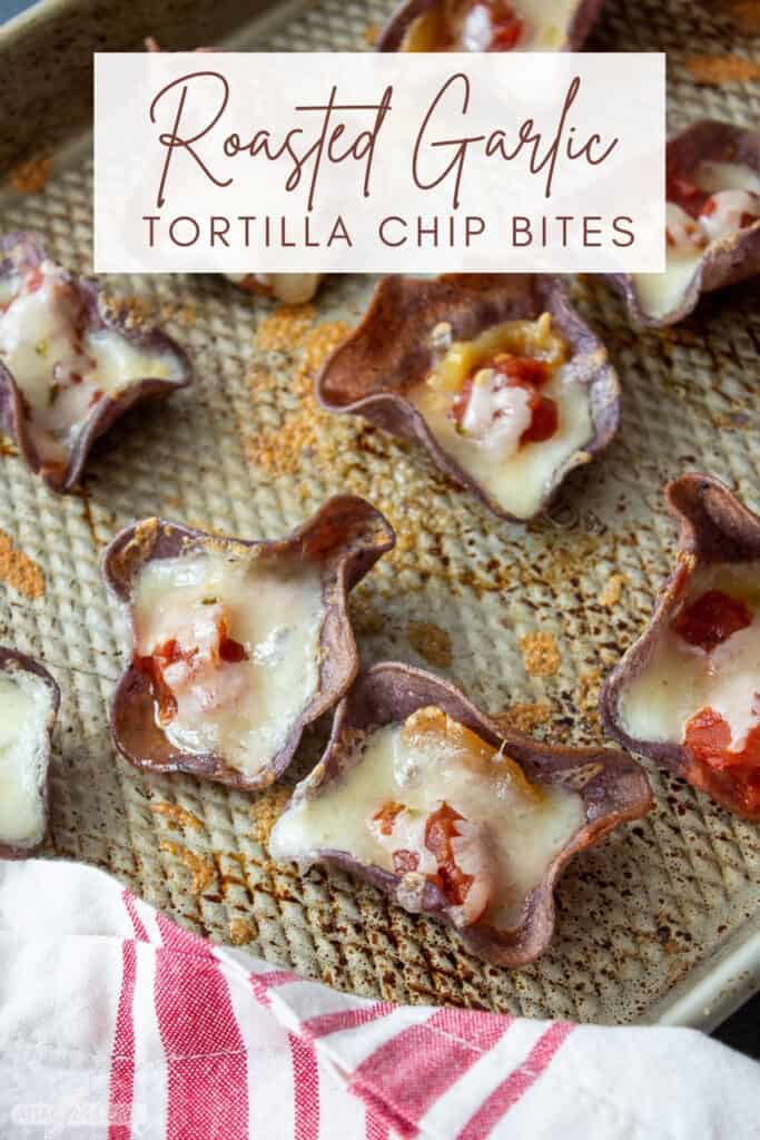 blue corn tortilla chips filled with cheese, roasted garlic and salsa on a sheet pan