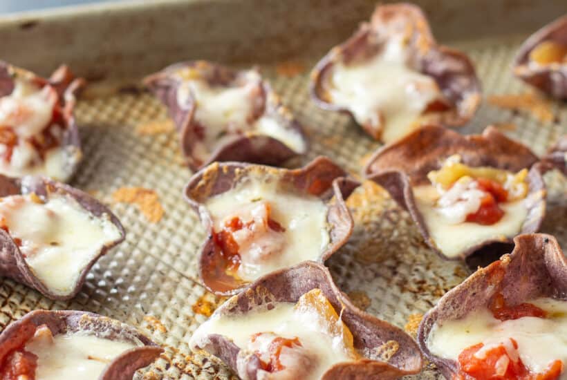roasted garlic tortilla chip appetizer on a sheet pan