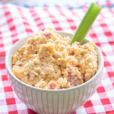 bowl of homemade pimento cheese with a celery stick