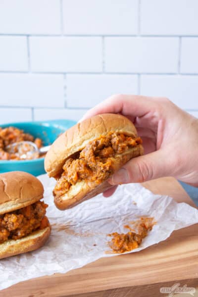 man's hand holding a sloppy Joes sandwich