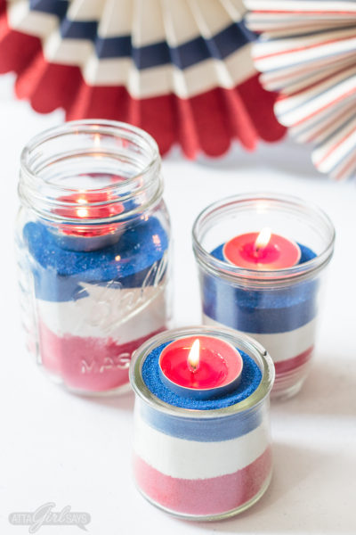 Looking for a easy patriotic decorating ideas for July 4th? Create an easy sand art centerpiece using mason jars, colorful sand and tealight candles. Kids will love helping with this project. Don't miss the video that shows you how to make them! #july4th #patriotic #sandart #redwhiteandblue #kidscrafts