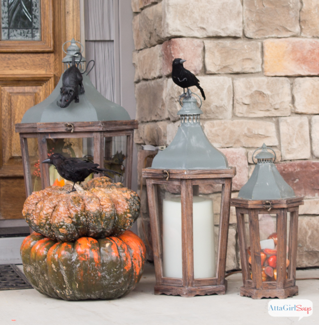 pumpkins and lanterns on a Halloween porch