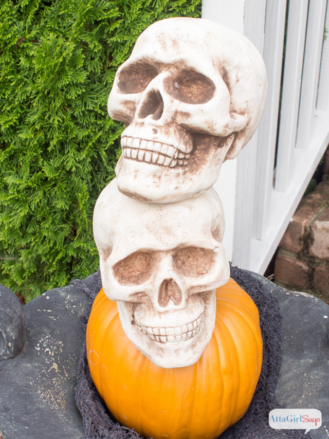 pumpkin and skull Halloween topiary in a planter are an example of inexpensive dollar store Halloween decorations