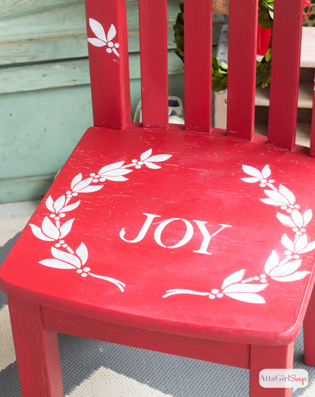 Use Christmas stencils to paint a child's chair for photos