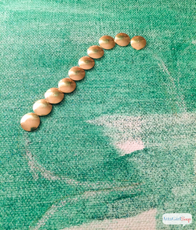 Use a painter's canvas and gold thumb tacks from the dollar store to make this lucky four leaf clover artwork. This is a great St. Patrick's Day project for kids.