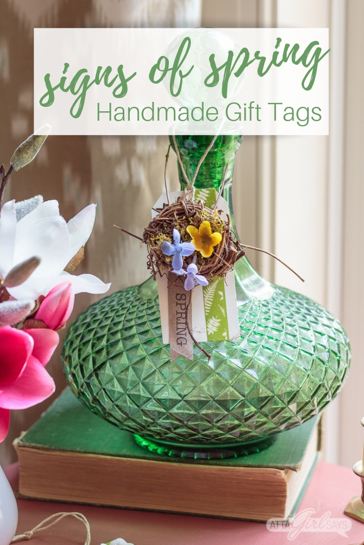 bird's nest on a spring tag hanging on a green glass bottle