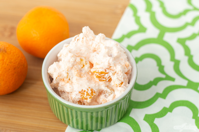 bowl of JELL-O orange salad on a green and white napkin