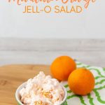 bowl of JELL-O orange salad on a green and white napkin
