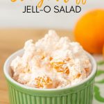 bowl of JELL-O orange salad on a green and white napkin