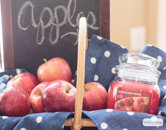 These fall table decorations were inspired by a trip to the farm. Apples, pumpkins, denim and candles in fabulous fall scents help set the scene. #LoveAmericanHome #ad #cbias