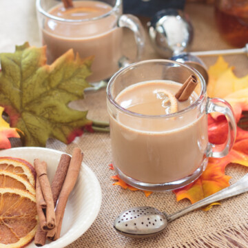 chai tea lattes on a fall table with dried orange slices