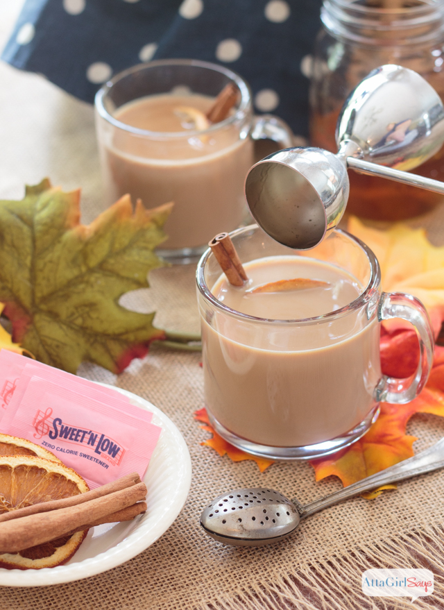 adding a shot of bourton to a mug of chai tea latte