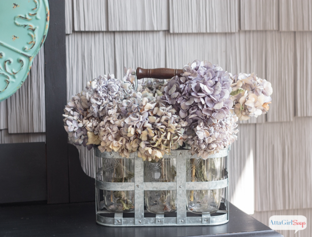 As much as I love the colors of autumn, it's refreshing to see fall front porch decor that embraces a completely different color palette. What a beautiful use of aqua, green, purple with neutrals.