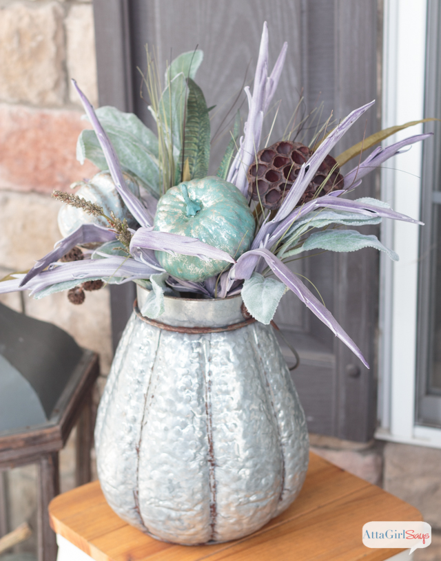 As much as I love the colors of autumn, it's refreshing to see fall front porch decor that embraces a completely different color palette. What a beautiful use of aqua, green, purple with neutrals.