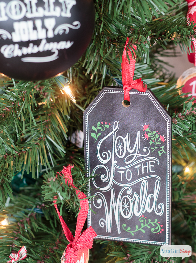 It all started with some gorgeous, wide chalkboard ribbon. Throw in a some vintage Christmas decorations, greenery and ample pops of red, and the result is a gorgeous front porch decorated for Christmas. Who wouldn't want to spend time relaxing in this beautiful space? It's so welcoming and festive!