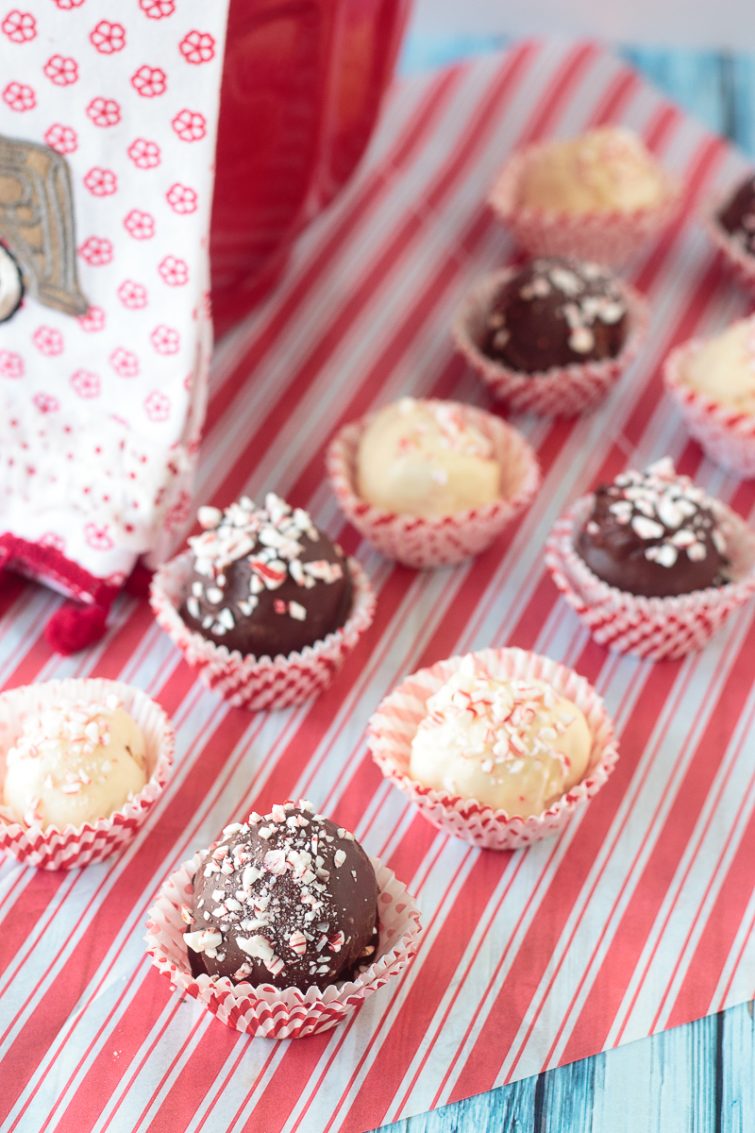white and dark chocolate peppermint candies on red and white parchment paper