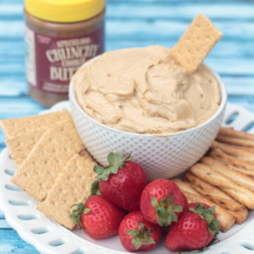 bowl of cookie butter dip with strawberries and graham crackers