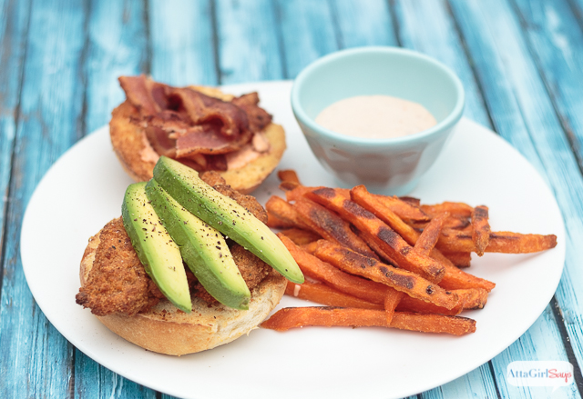 The next time you're craving fast food, give this chicken sandwich recipe a try. Fried southern-style chicken with spicy ranch sauce, bacon and avocado slices, paired with sweet potato fries with a homemade spicy boom-boom dipping sauce. #ad #farmtoflavorrecipes