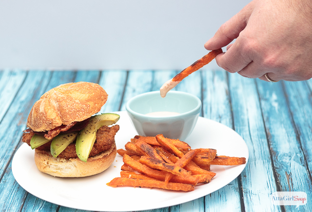 The next time you're craving fast food, give this chicken sandwich recipe a try. Fried southern-style chicken with spicy ranch sauce, bacon and avocado slices, paired with sweet potato fries with a homemade spicy boom-boom dipping sauce. #ad #farmtoflavorrecipes