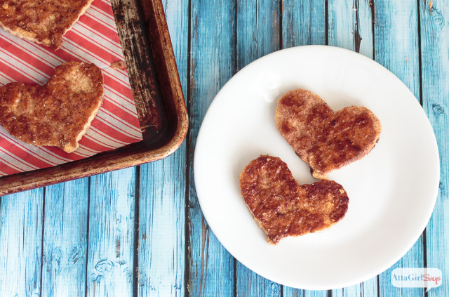cinnamon sugar heart cookies on a plate with a baking sheet