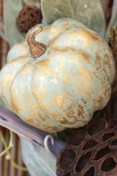 sage green painted pumpkin with gold metallic accents