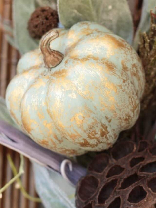sage green painted pumpkin with gold metallic accents