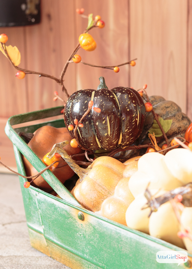These fall fireplace mantel decorating ideas combine cedar wood, cotton bolls, pumpkins, lanterns and colorful fall leaves. The design is inspired by a rustic fall harvest.