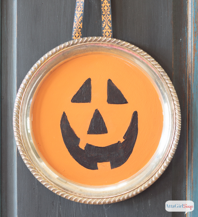 jack-o-lantern painted on a silver tray