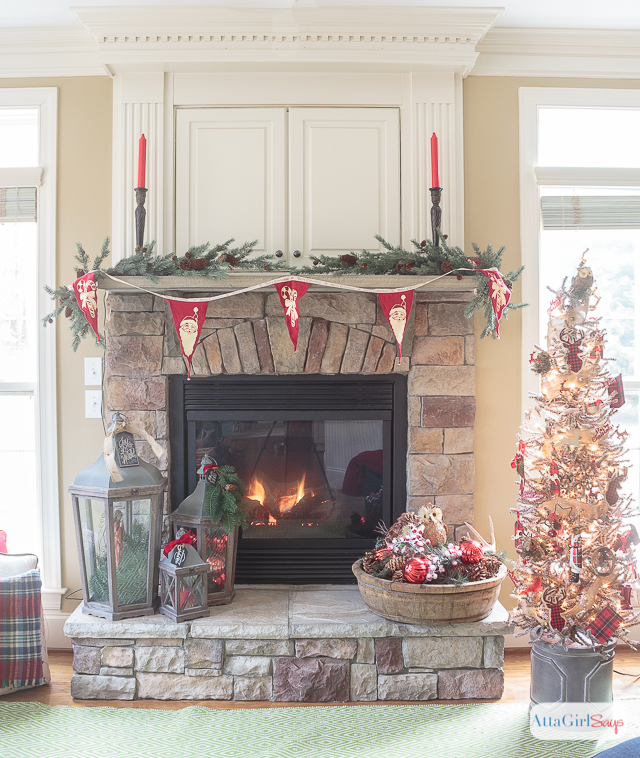 I love all the vintage and rustic Christmas decor she used to decorate this gorgeous stone fireplace mantel for the holidays.