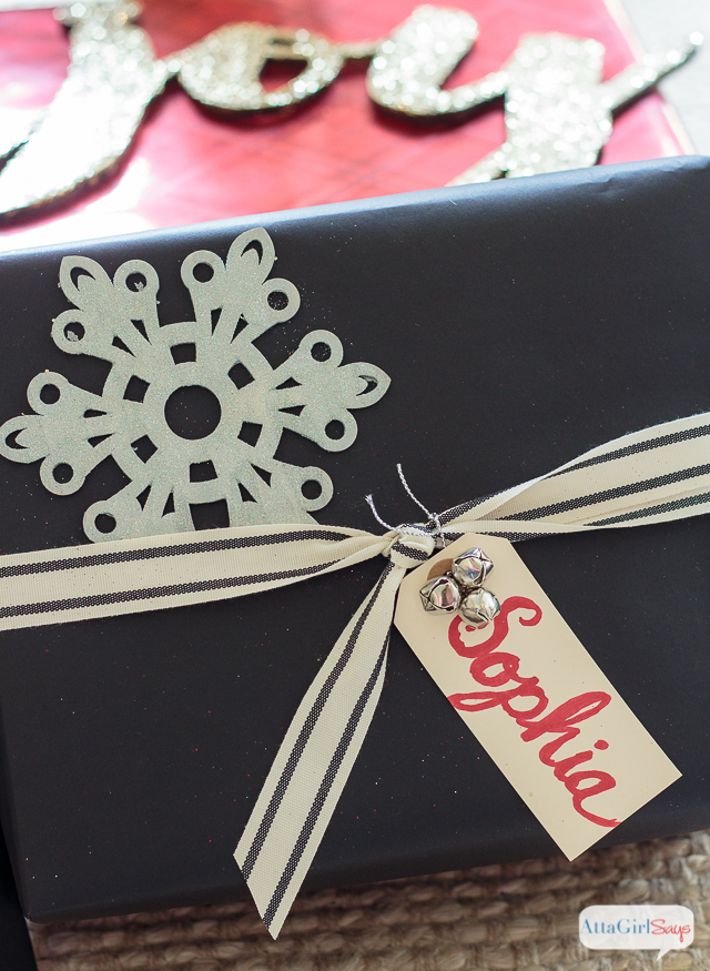 You don't need expensive paper or fancy ribbon to wrap beautiful gifts. Check out these inexpensive Christmas gift wrapping ideas, including tips for dressing up plain wrapping paper, a tutorial to make make glittery package toppers and a technique for making gift bags out of any kind of paper you have on hand. #ad #decoartprojects 