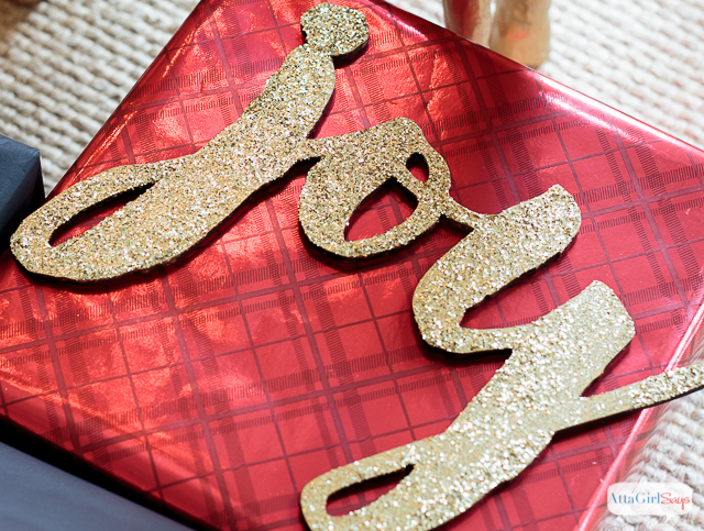 You don't need expensive paper or fancy ribbon to wrap beautiful gifts. Check out these inexpensive Christmas gift wrapping ideas, including tips for dressing up plain wrapping paper, a tutorial to make make glittery package toppers and a technique for making gift bags out of any kind of paper you have on hand. #ad #decoartprojects 