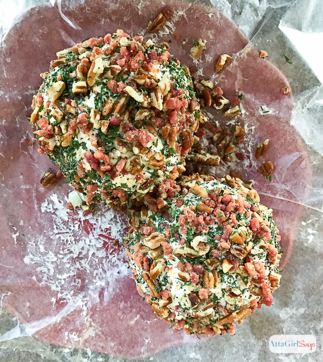 homemade cheese balls rolled in nuts sitting on wax paper