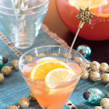 glass of holiday spiked punch with orange slices
