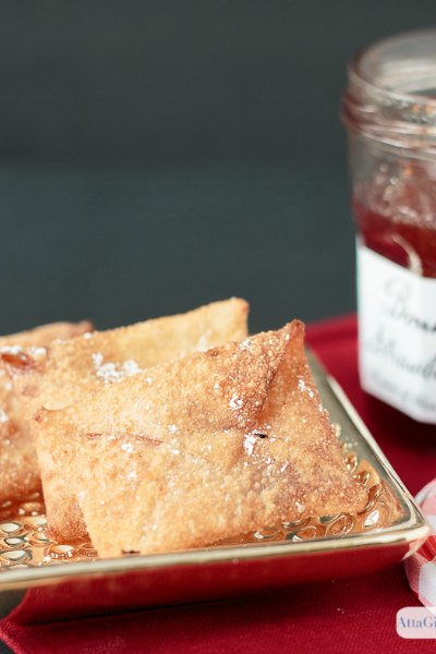 fried wontons folded to look like envelopes with strawberry jelly