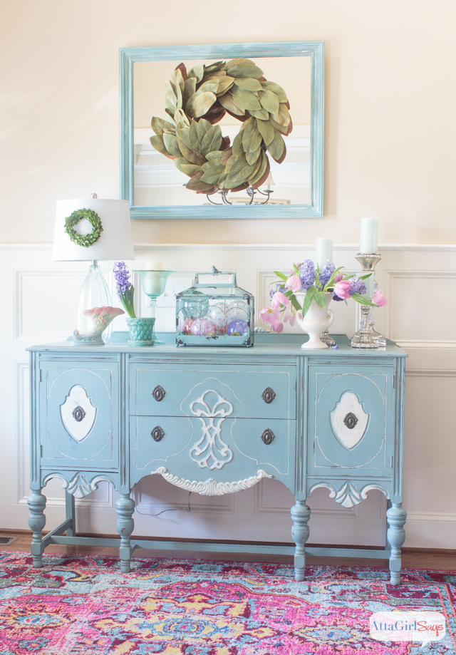 colorful spring foyer with a pink rug and a blue buffet