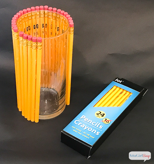 Welcome your favorite teacher back to school with a thoughtful, homemade teacher appreciation gift. This vase is made from dozens of No. 2 pencils affixed to a glass vase. Add a bouquet of gorgeous white lilies and yellow mums. 