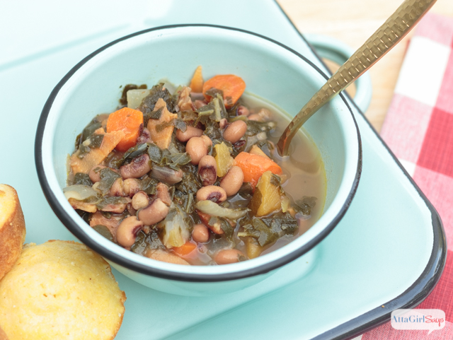 bowl ofhearty black eyed pea soup with collards, ham and root vegetables