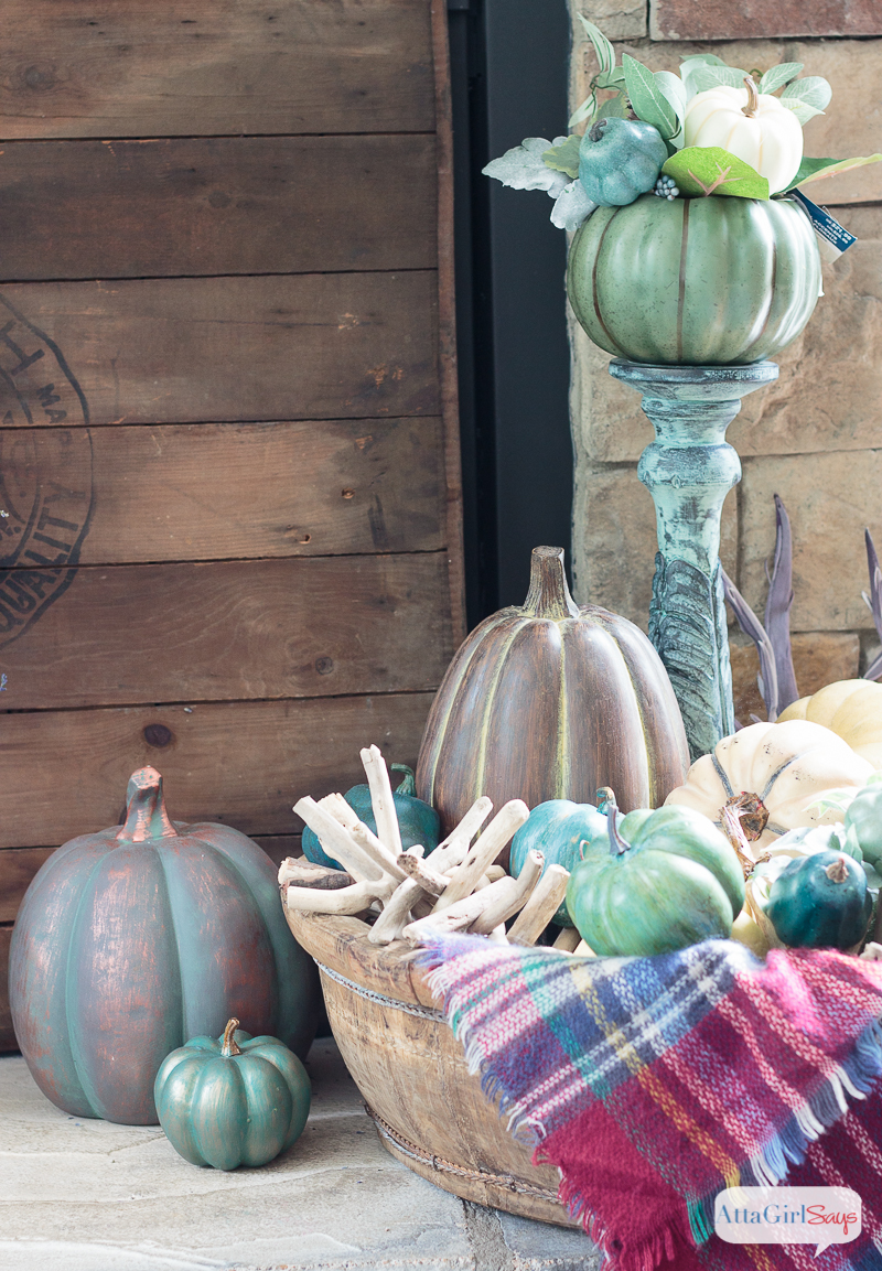 A cozy plaid blanket scarf inspired my fall fireplace mantel decor. Rather than traditional orange and yellow, I decorated with pops of aqua, indigo and purple. Be sure to click to see more gorgeous fall mantels.