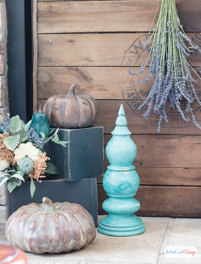 A cozy plaid blanket scarf inspired my fall fireplace mantel decor. Rather than traditional orange and yellow, I decorated with pops of aqua, indigo and purple. Be sure to click to see more gorgeous fall mantels.