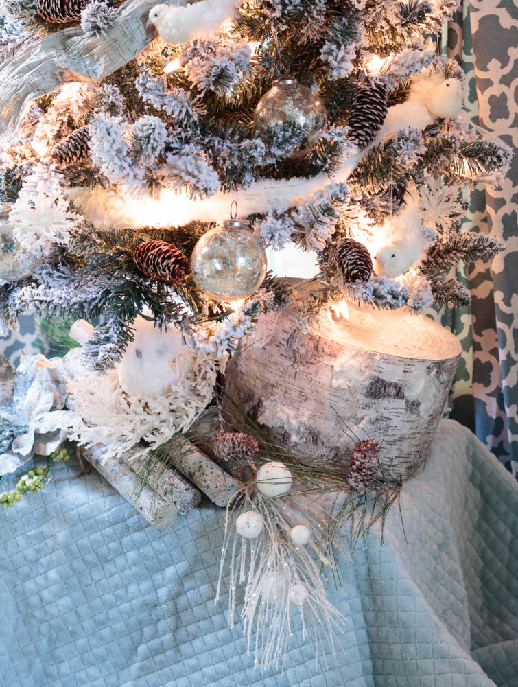 Stunning blue-and-white Christmas decorations featuring a flocked tree, mercury glass, birds and snowy branches. So many wonderful Christmas mantel ideas here. #sponsored #AtHomeStores