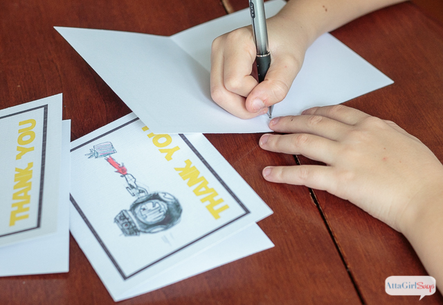 child writing a thank you note