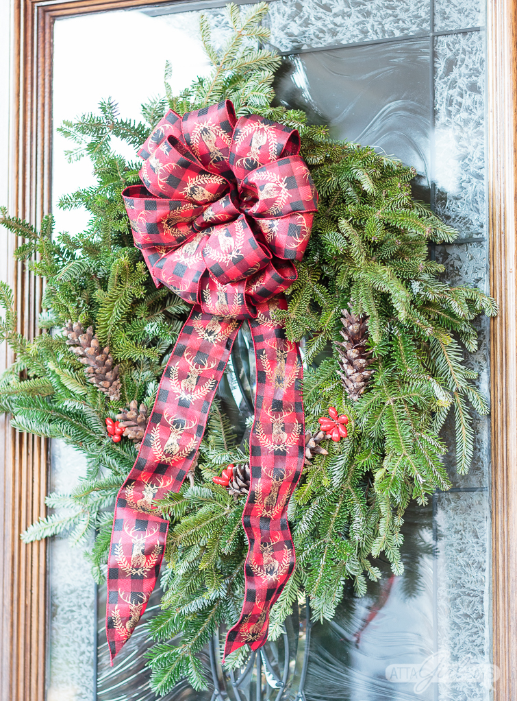 Tour this beautiful southern front porch decorated in vintage style for Christmas. You'll love the use of lanterns, beautiful ribbon and vintage thrifted finds in this stunning space. Which of these Christmas porch decor ideas would you use at your home?