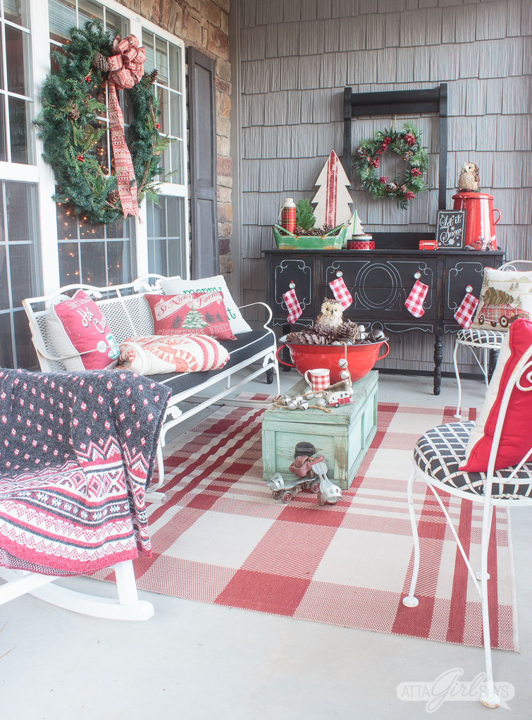 Tour this beautiful southern front porch decorated in vintage style for Christmas. You'll love the use of lanterns, beautiful ribbon and vintage thrifted finds in this stunning space. Which of these Christmas porch decor ideas would you use at your home? 