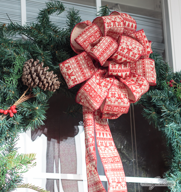 Tour this beautiful southern front porch decorated in vintage style for Christmas. You'll love the use of lanterns, beautiful ribbon and vintage thrifted finds in this stunning space. Which of these Christmas porch decor ideas would you use at your home?