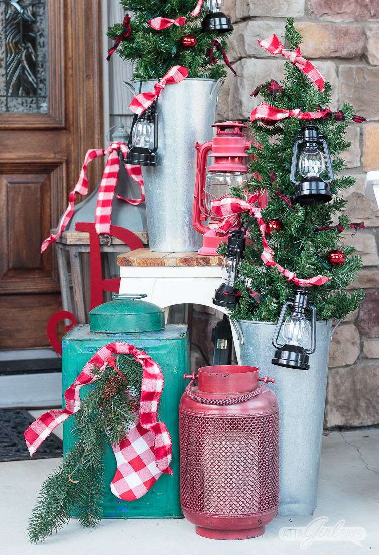 Tour this beautiful southern front porch decorated in vintage style for Christmas. You'll love the use of lanterns, beautiful ribbon and vintage thrifted finds in this stunning space. Which of these Christmas porch decor ideas would you use at your home? 