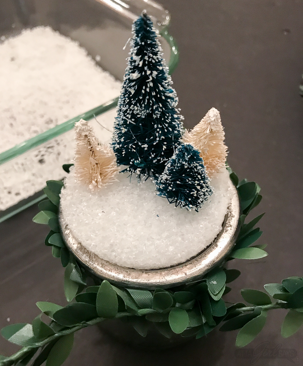 Turn glass yogurt jars into stunning sea glass and mercury glass votives. Add bottlebrush trees, greenery, tinsel and faux snow and use them as part of your Christmas decor. Click for step-by-step instructions and a complete supply list for making them. Plus check out the other ideas for repurposing jars and decorating with jars.