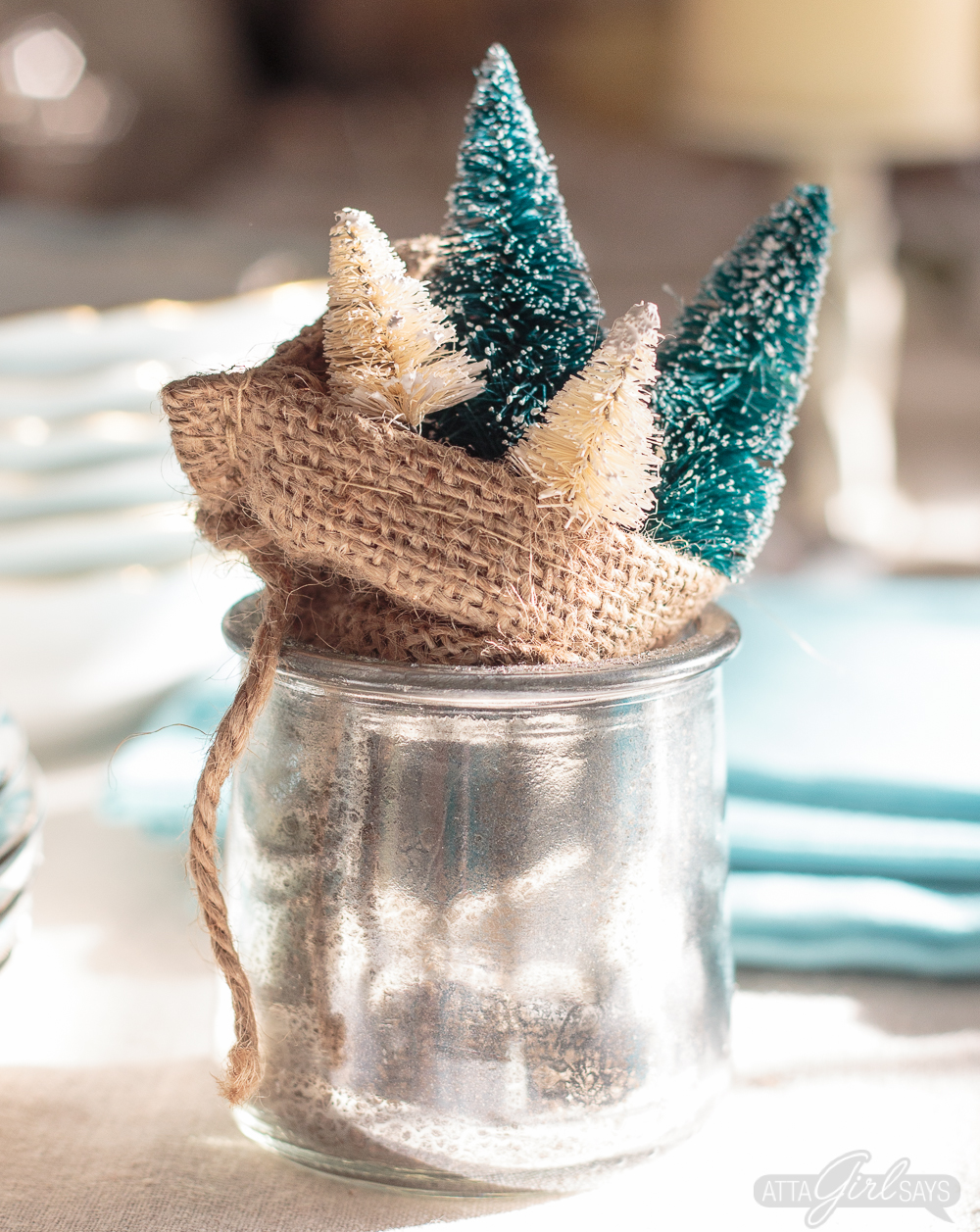 Turn glass yogurt jars into stunning sea glass and mercury glass votives. Add bottlebrush trees, greenery, tinsel and faux snow and use them as part of your Christmas decor. Click for step-by-step instructions and a complete supply list for making them. Plus check out the other ideas for repurposing jars and decorating with jars.