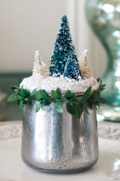Turn glass yogurt jars into stunning sea glass and mercury glass votives. Add bottlebrush trees, greenery, tinsel and faux snow and use them as part of your Christmas decor. Click for step-by-step instructions and a complete supply list for making them. Plus check out the other ideas for repurposing jars and decorating with jars.